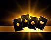 4 casino playing cards in front of shining light